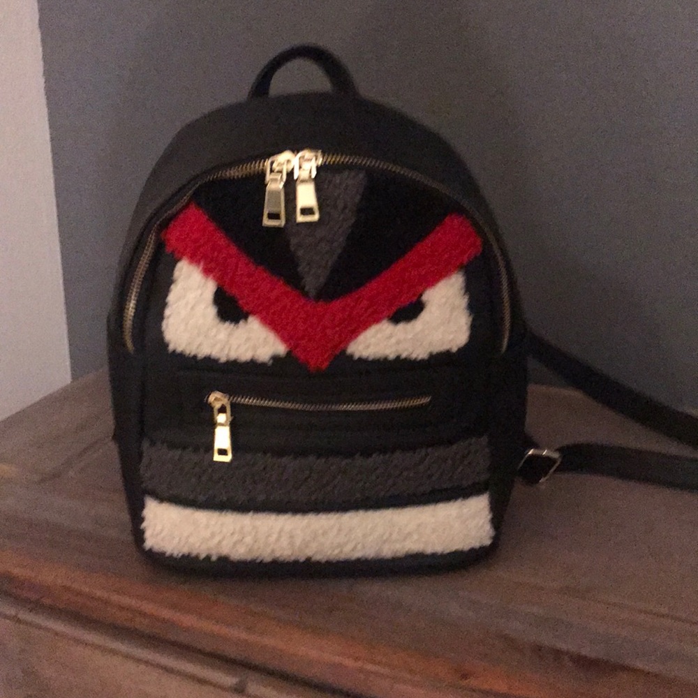 Gently used backpack with monster face.